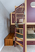 Loft bed, cat on the stairs and patterned wallpaper in the children's room