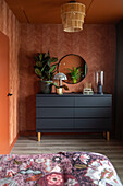 Anthracite sideboard, round mirror, plant and lamp