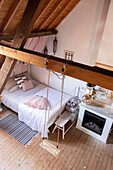 Cosy attic bedroom with swing and wood-burning stove