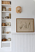 Shelf with neutral decorative elements and botanical mural