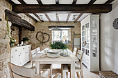Country-style dining room with wooden beams and natural stone walls
