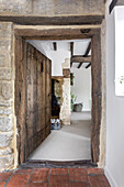 Entrance area with rustic wooden door and stone walls in a country house