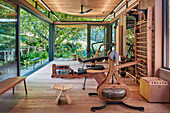 Fitness room with wooden elements and garden view