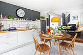 Modern kitchen with dining area and yellow pendant light
