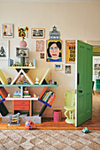 Colourful room with creative wall decoration and green door