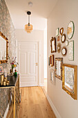 Hallway with vintage mirror wall and floral wallpaper