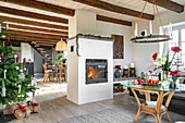 Living room with Christmas decorations, fireplace and exposed beams