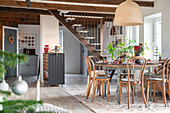 Country-style dining room with wooden furniture and exposed ceiling beams