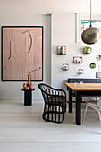 Dining area, artwork and decorative objects on a white wall