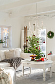 Living room decorated for Christmas with Christmas tree and candlestick