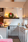 Kitchen interior with white furnishings and Christmas decorations