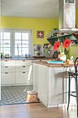 Bunte Landhausküche mit Retro-Accessoires und gelben Wänden