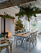 Festively decorated dining area with Christmas tree and tinsel garlands