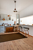 Kitchen with bar stools and wooden elements