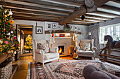 Living room with fireplace and traditional-style Christmas decorations