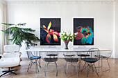 Bright dining area with modern art and designer chairs