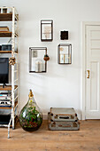 Living room with plant terrarium, wall decorations and vintage suitcases