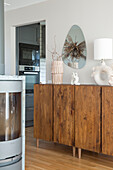 Wooden sideboard with decorative objects in a modern ambience