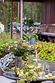 Outdoor patio table with fresh summer flowers and drinks
