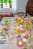 Festively laid dining table with floral arrangements and candlelight