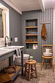 Bathroom with grey panelled walls and patterned floor