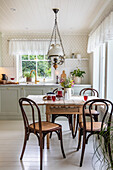 Country kitchen with dining table and coffee house chairs
