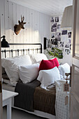 Bedroom with metal bed, photo wall and deer antler decor