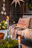 Cosy sofa with cushions, blanket, fur and Christmas decorations