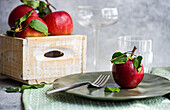 Table setting decorated with ripe red apples for holiday autumnal dinner