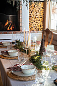 Dining room with Christmas table decorations and fireplace in the background
