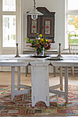 Dining table with bouquet of flowers and candles, country style