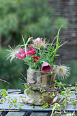 DIY vase made of jar and sacking with pasque flower (Pulsatilla)