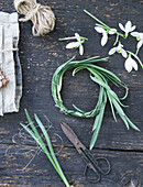 Tying a wreath of snowdrops