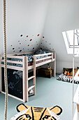 Loft bed in children's room, wall decorated with dots