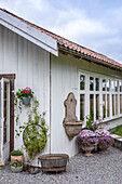 Country-style veranda with flowers and vintage garden sink