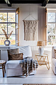 Cosy reading corner with macramé wall hanging and decorative cushions in the living room