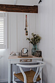 Compact dressing table with mirror, white-painted wooden walls