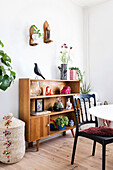 Vintage wooden shelf with decorative items in the dining room