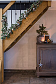 Christmas staircase decoration with fir garland and lights