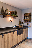 Country-style kitchen furnishings with rustic wall shelves and Christmas decorations