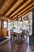 Rustic dining area with wooden table, metal pendant lights and exposed beams