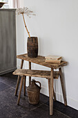 Rustic wooden table with vase and dried plant