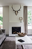 Living room with fireplace and deer antlers on the wall
