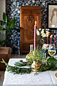 Festive table decoration with fir branches and candles