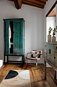 Bedroom with vintage wardrobe and modern chair