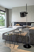 Modern living room with floor lamp, side tables and fireplace