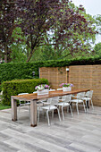 Wooden table with metal chairs on a terrace