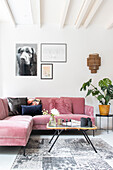 Living room with pink corner sofa and wall art