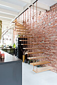 Hanging staircase on red brick wall