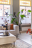 Bright living room with large houseplant and decorative star motifs